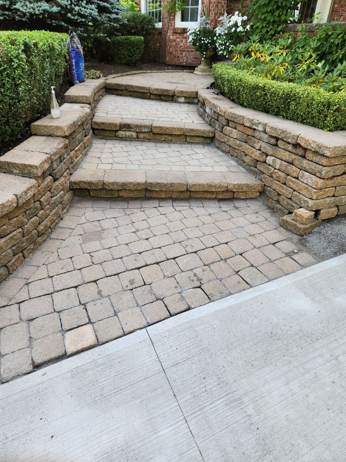 Stone paver walkway and retaining walls at home entrance
