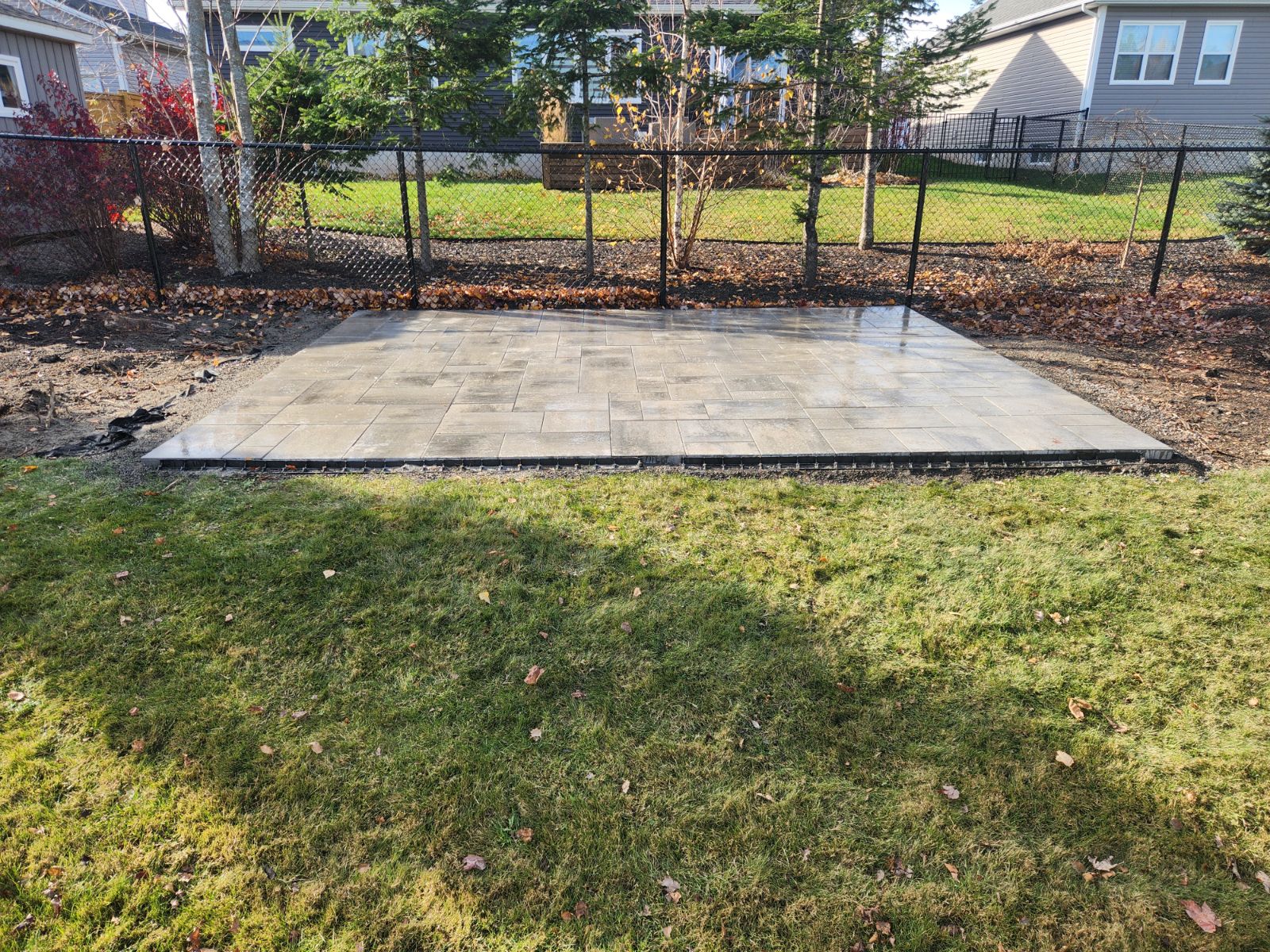 Completed paver patio in residential backyard